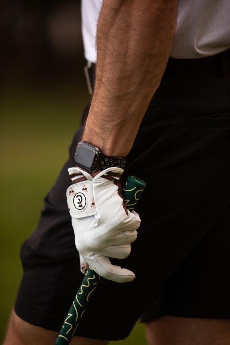 golf player wearing white glove and black shorts